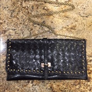 Black studded woven leather cross body bag.